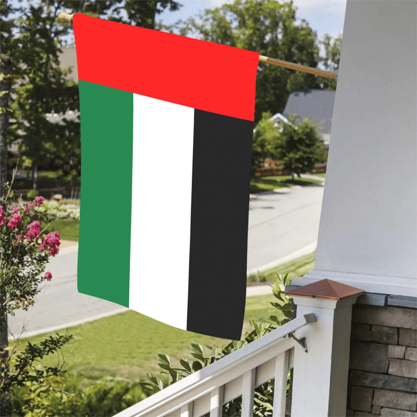[Luv My Flag] Pan-African flag displayed on wooden porch pole.