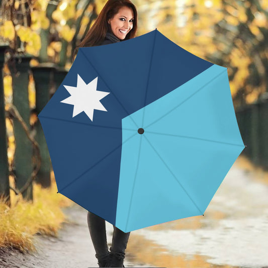 Smiling woman holding [Brand] blue umbrella with star design.