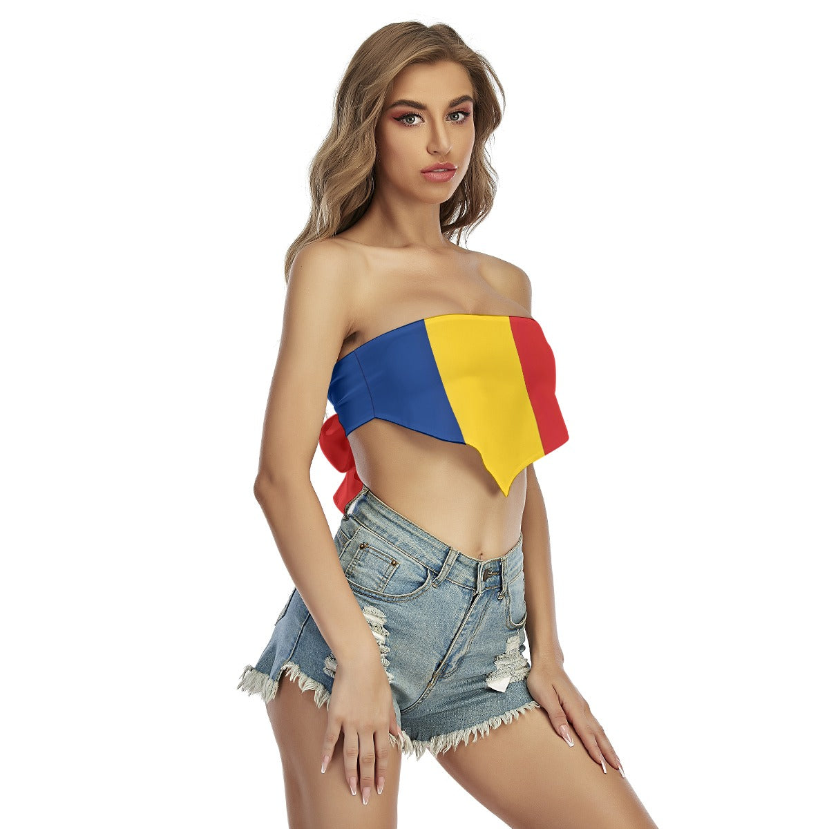 Woman in [Brand] bandeau top and denim shorts, posing.
