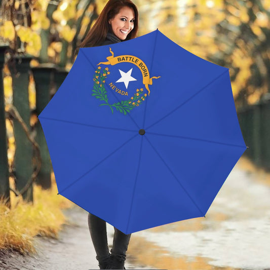 Woman holding Nevada-themed blue umbrella from [Brand]. Smiling outdoors.