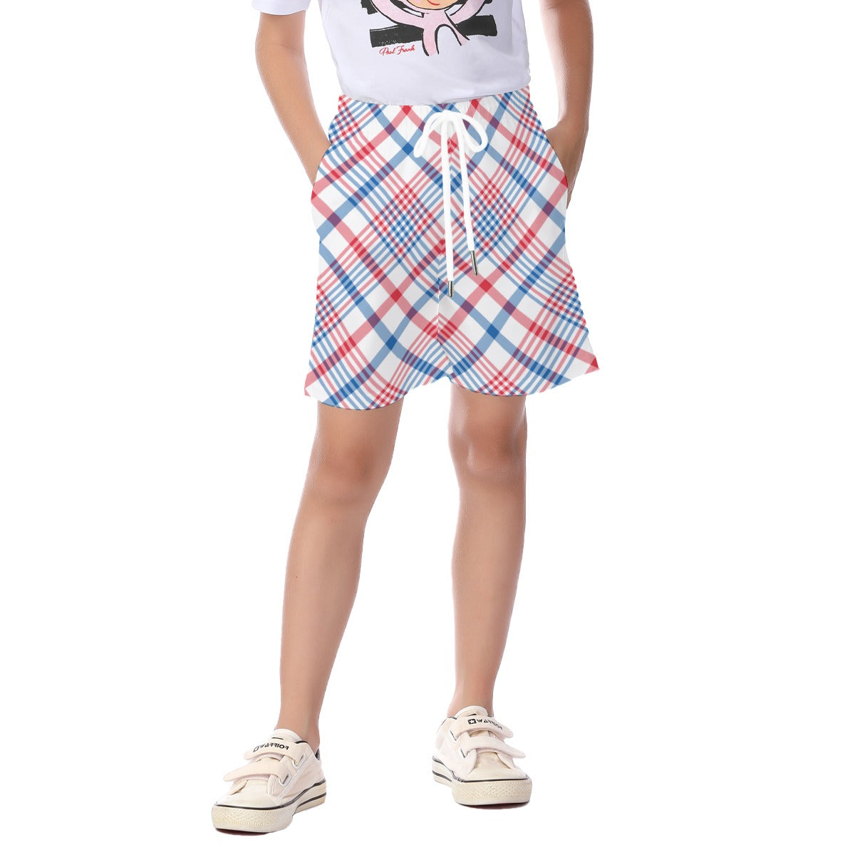 Young person wearing [Brand] plaid shorts and white sneakers.