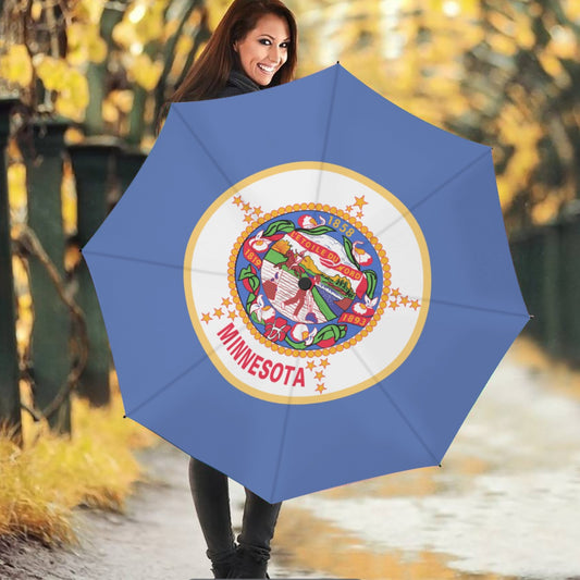 Smiling woman holding [Brand] umbrella with Minnesota emblem.