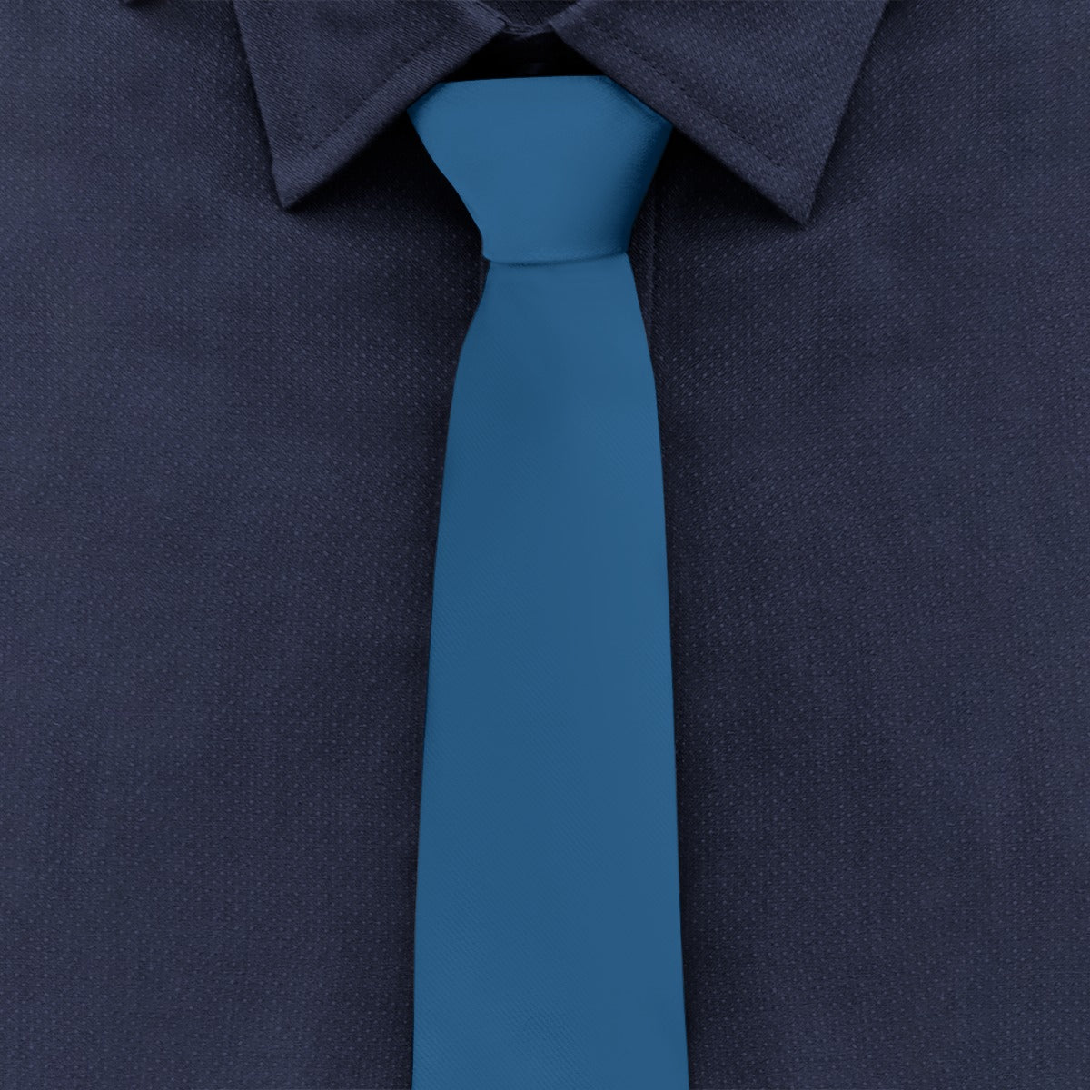 [Brand] navy shirt with blue tie, close-up view.
