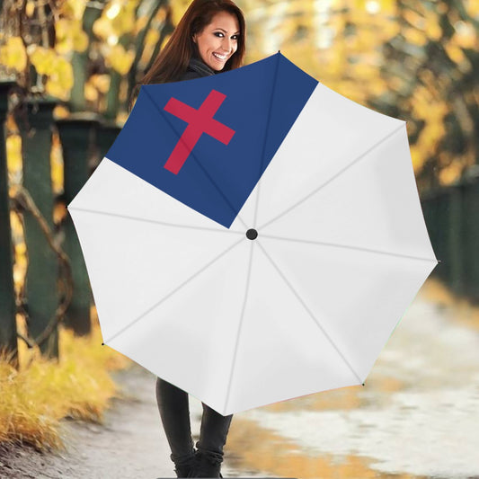 Woman holding [Brand] umbrella with cross design, autumn background.