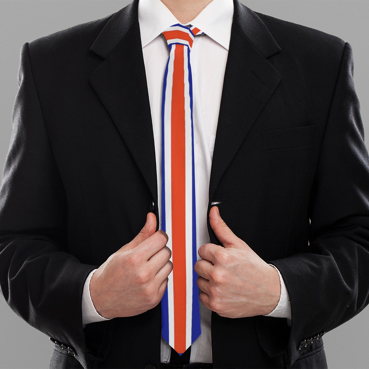 Person in black suit wearing [Brand] red-white-blue striped tie.