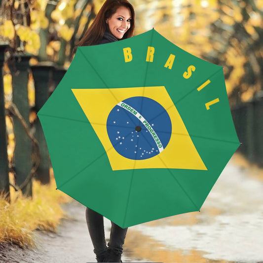 Smiling woman holds [Brand] Brazil flag umbrella, autumn background.