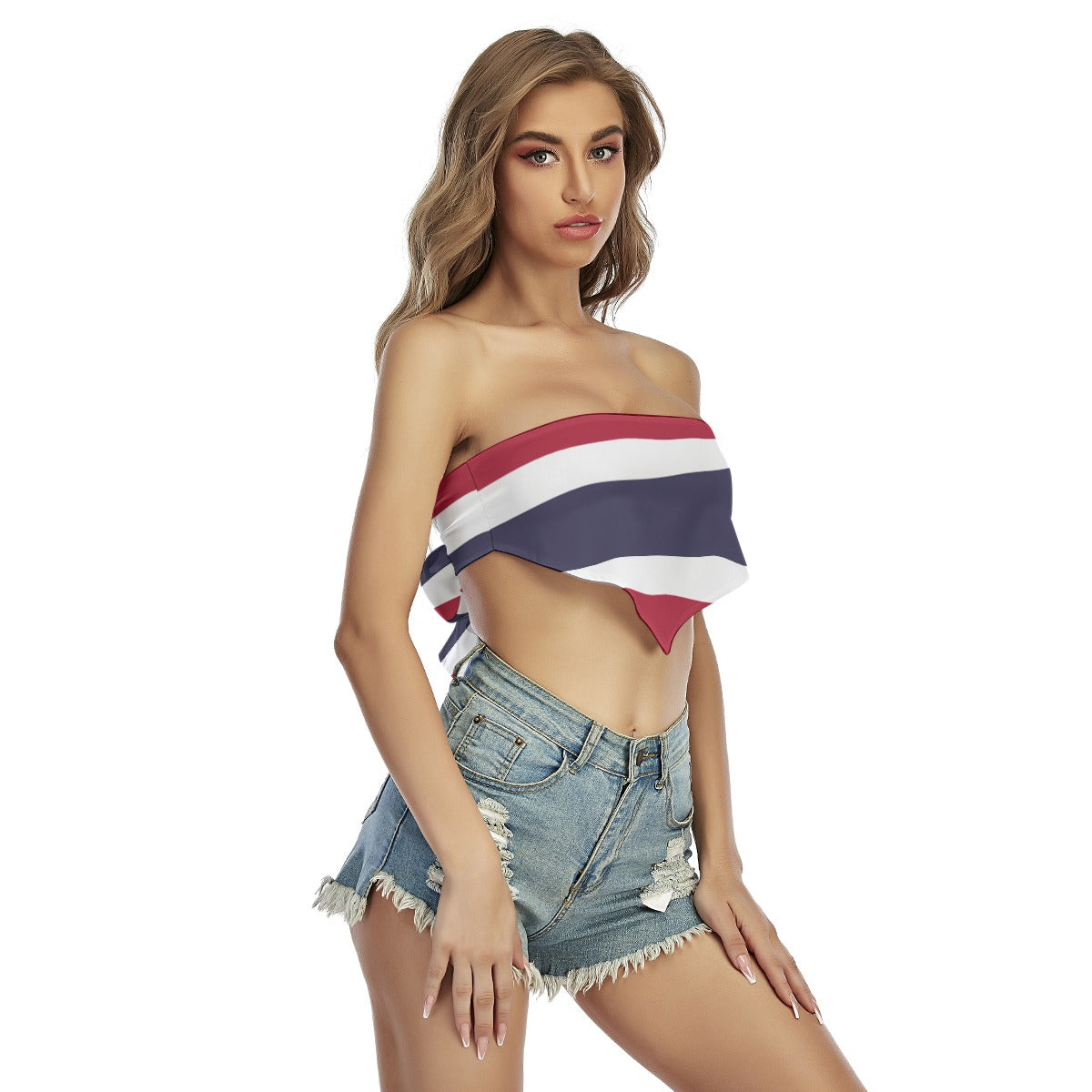 Woman wearing [Brand] striped top and denim shorts, standing confidently.