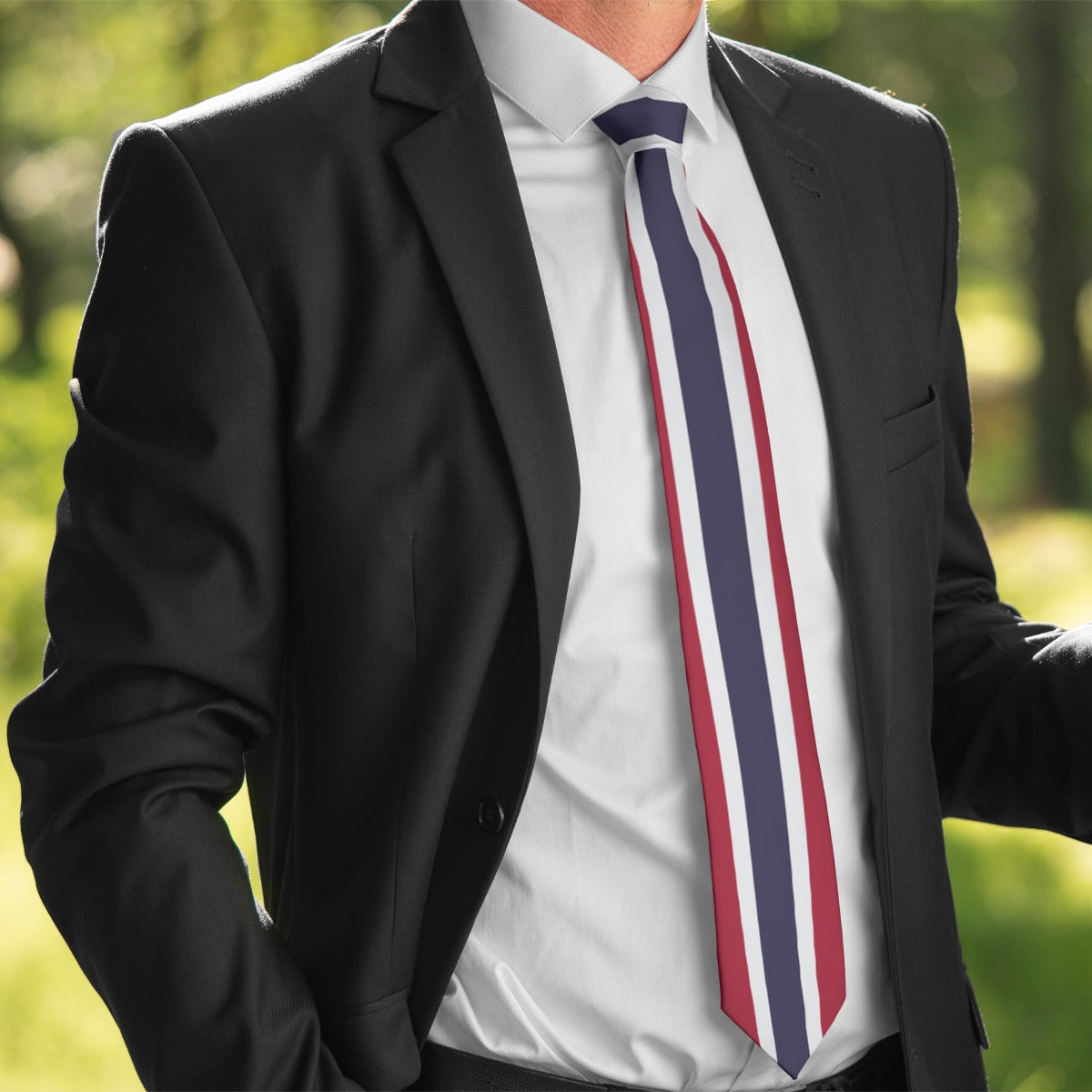 Man in black suit wearing [Brand] tricolor striped tie.
