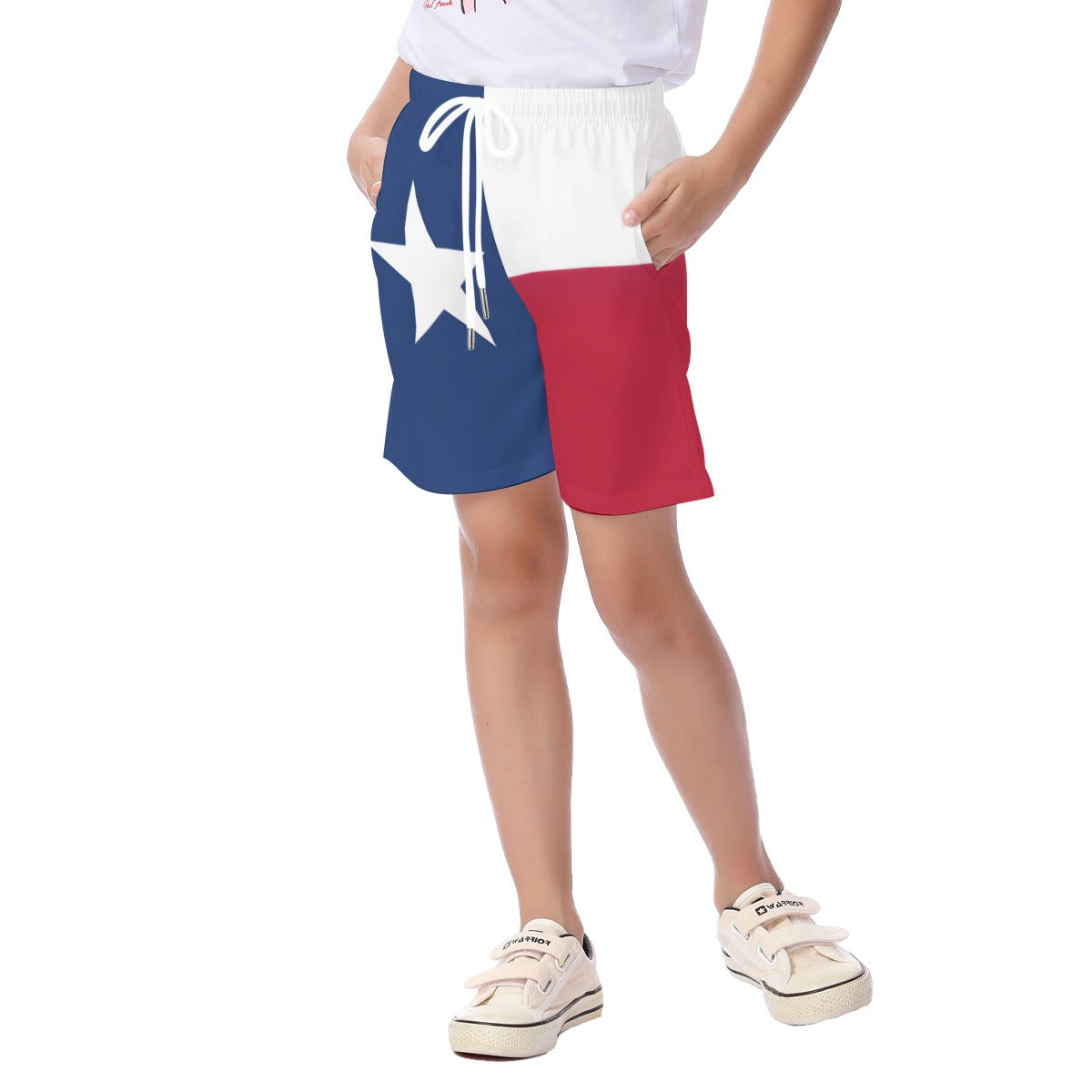 Child wearing [Brand] Texas flag themed shorts, white sneakers.