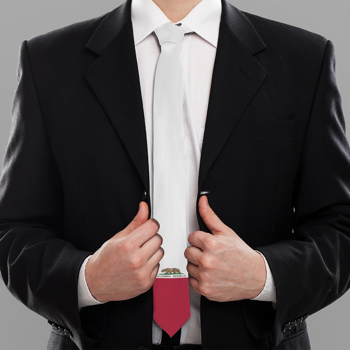 Man in suit adjusting jacket displaying [Brand] tie.