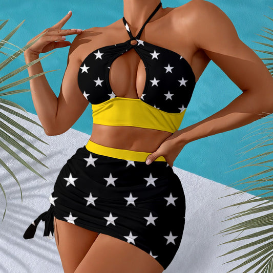 Model in Luv My Flag star-patterned swimsuit, beach background.