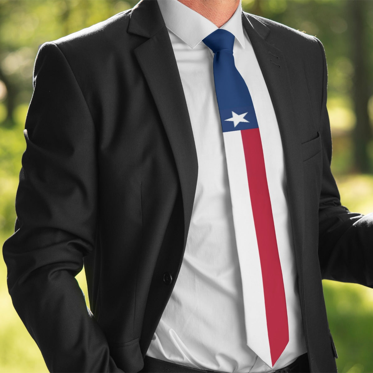 Man in suit wearing [Brand] Texas flag-themed necktie outdoors.
