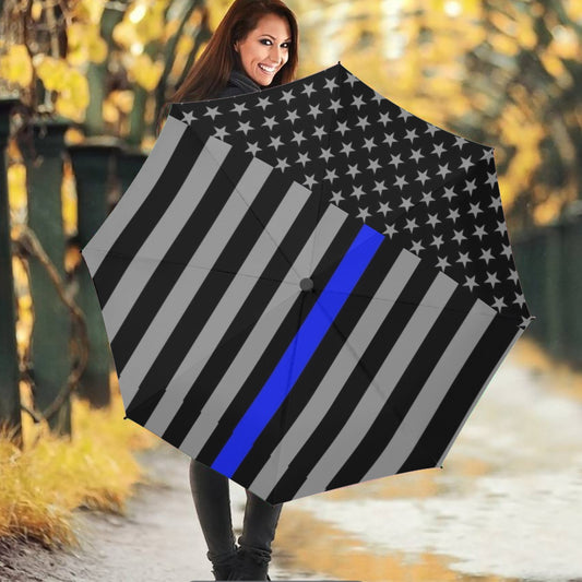 Smiling woman holding [Brand] umbrella with striped design.