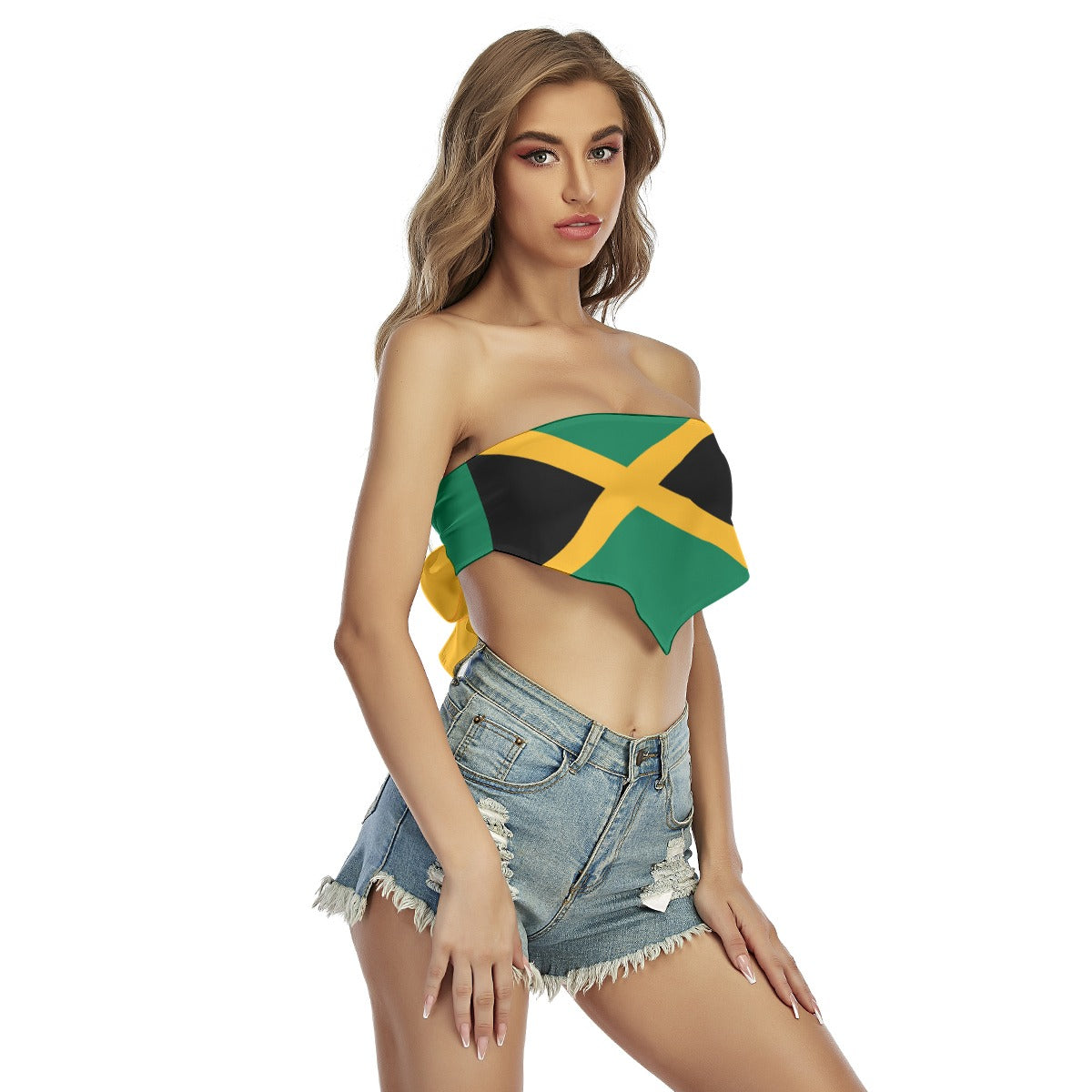 Woman wearing [Brand] Jamaica flag top, denim shorts, confidently posing.