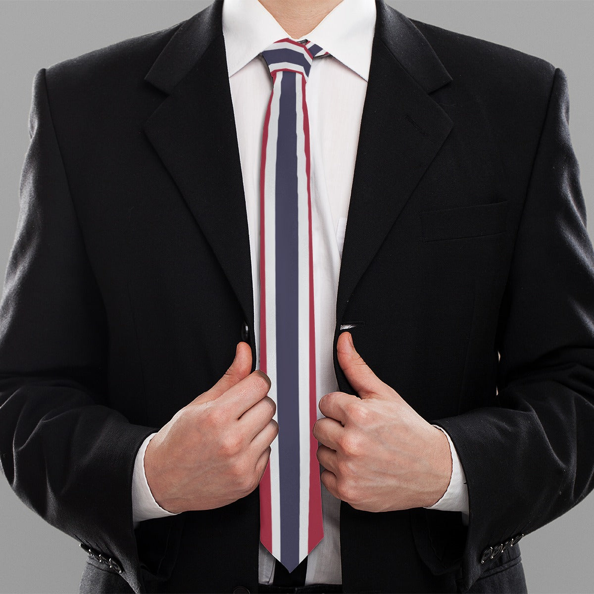 Person in black suit wearing [Brand] striped necktie, gray background.