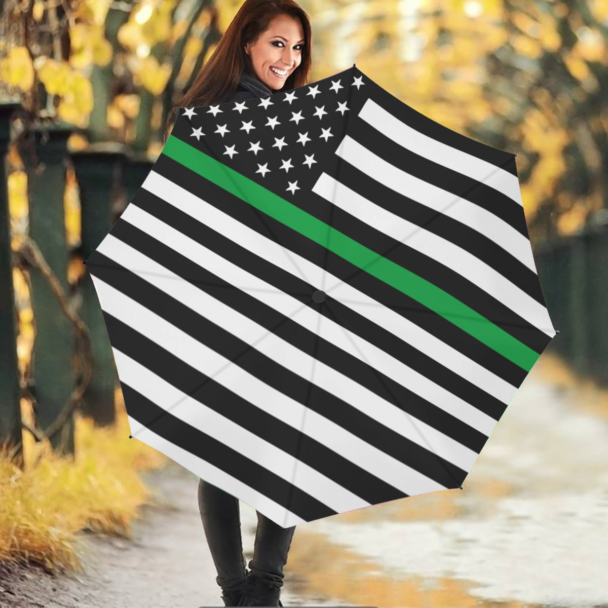 Smiling woman holding [Brand] umbrella with American flag design.
