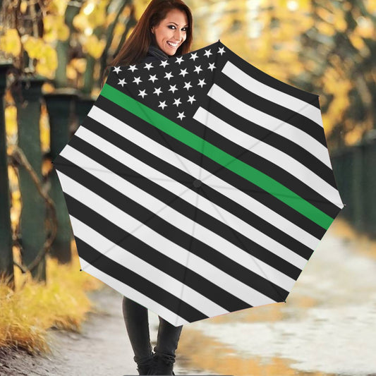 Smiling woman holding [Brand] umbrella with American flag design.
