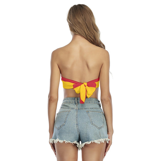 Rear view of woman in [Brand] colorful top, shorts.