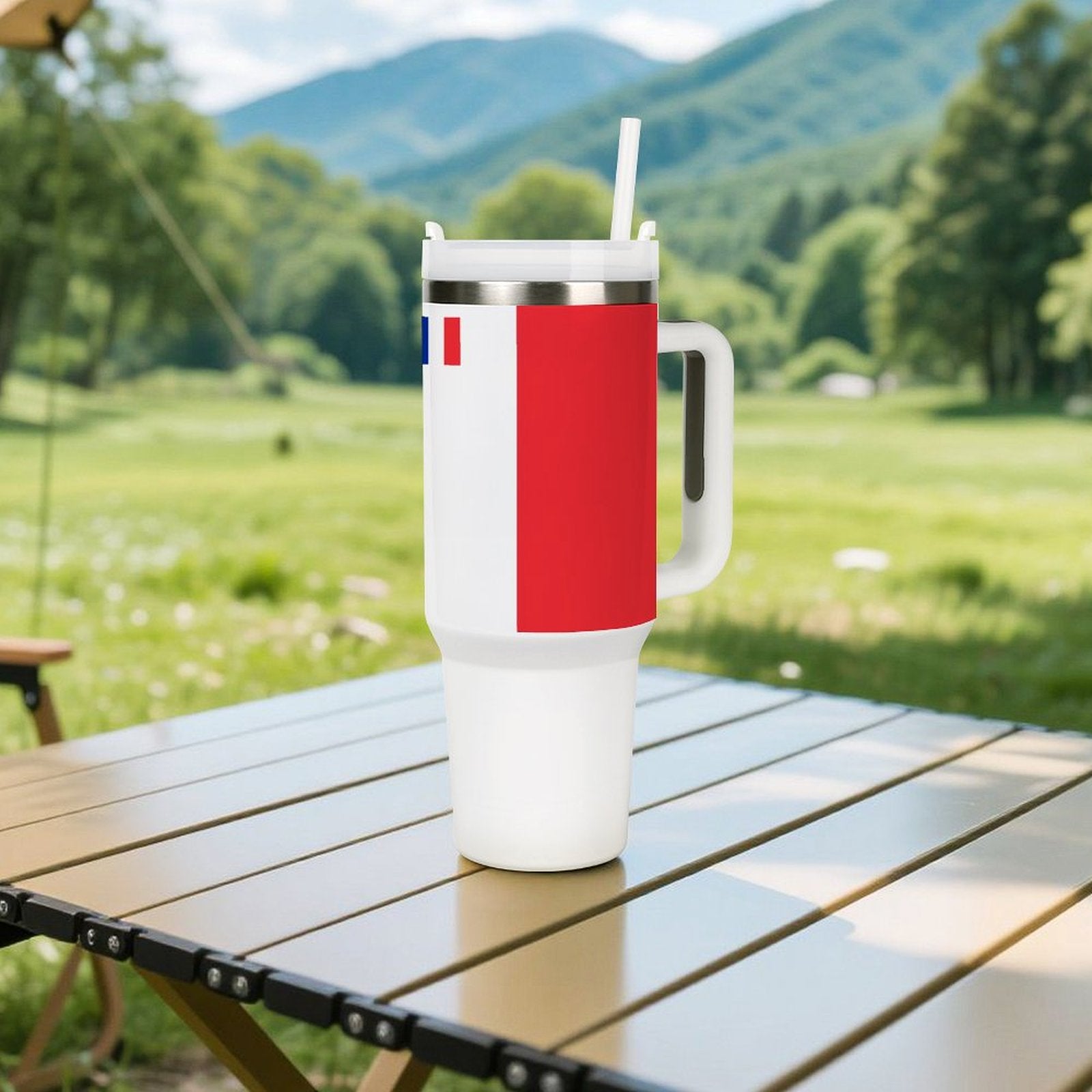 [Brand] tumbler with handle on table, lush green background.