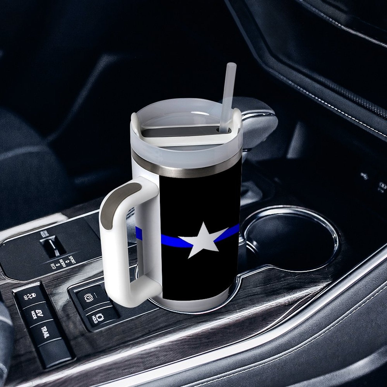 [Brand] travel mug with a handle in car's cup holder.
