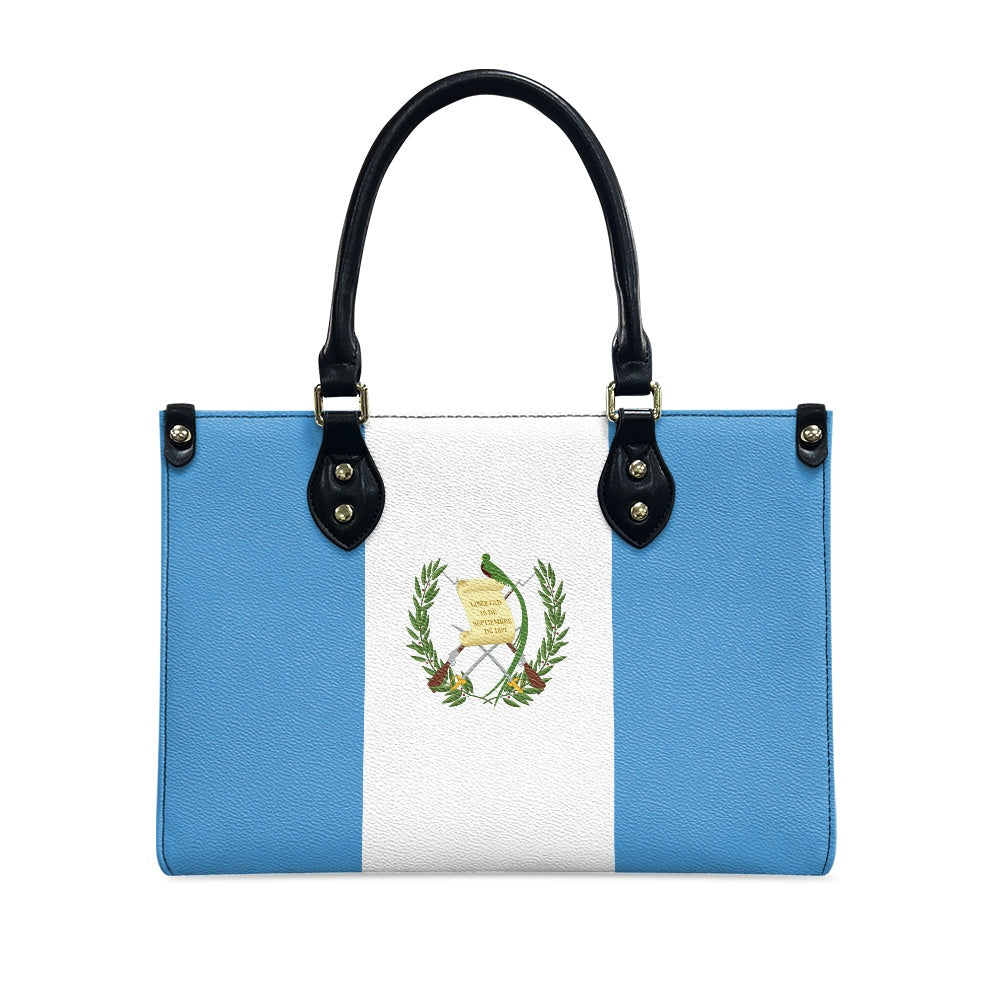 [Brand] handbag with Guatemalan flag design and black handles.