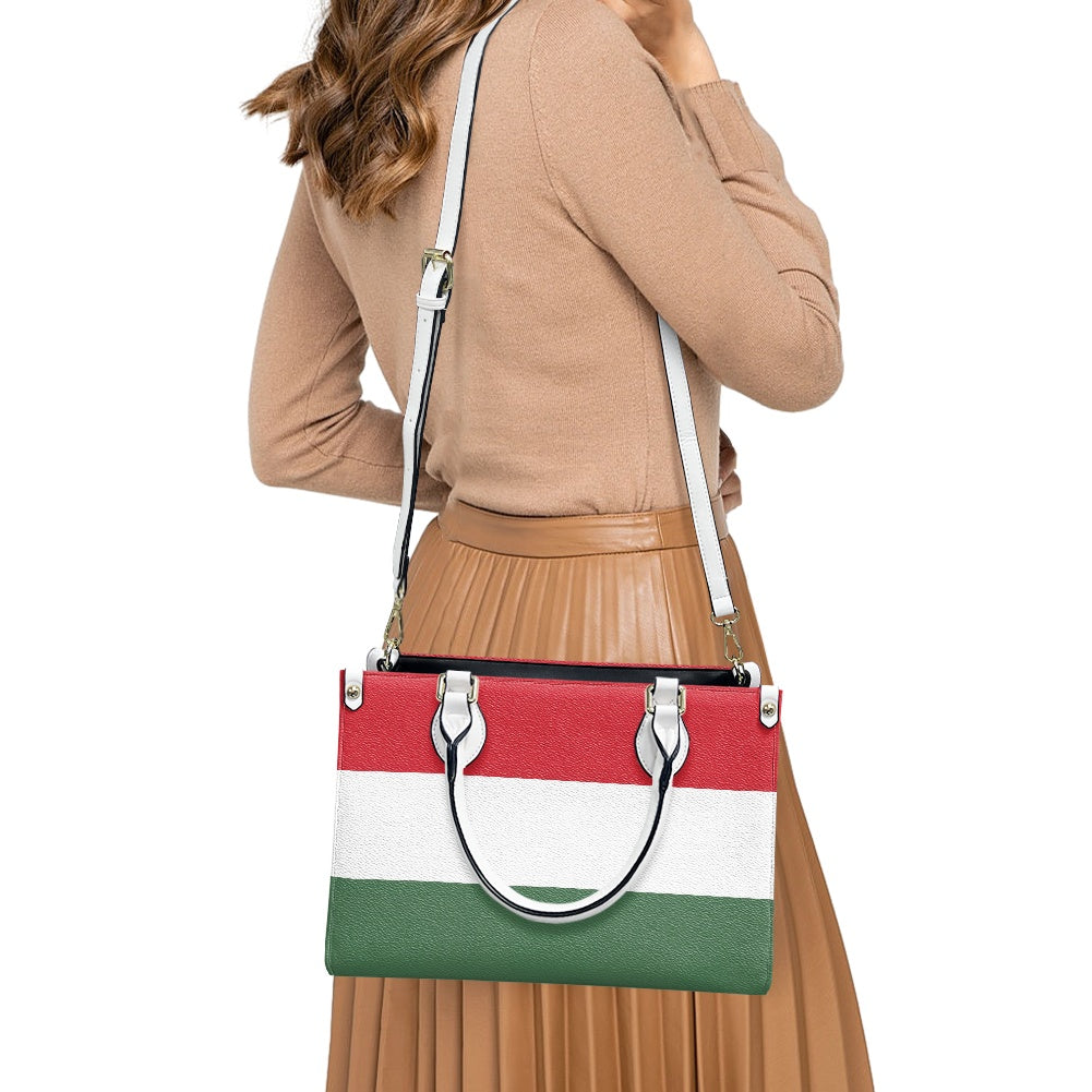 Woman carries [Brand] handbag with red, white, green stripes.