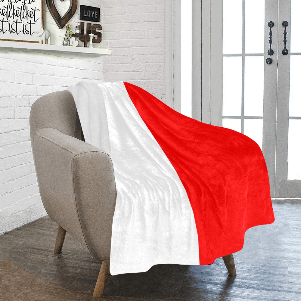 Red and white Luv My Flag blanket on armchair.