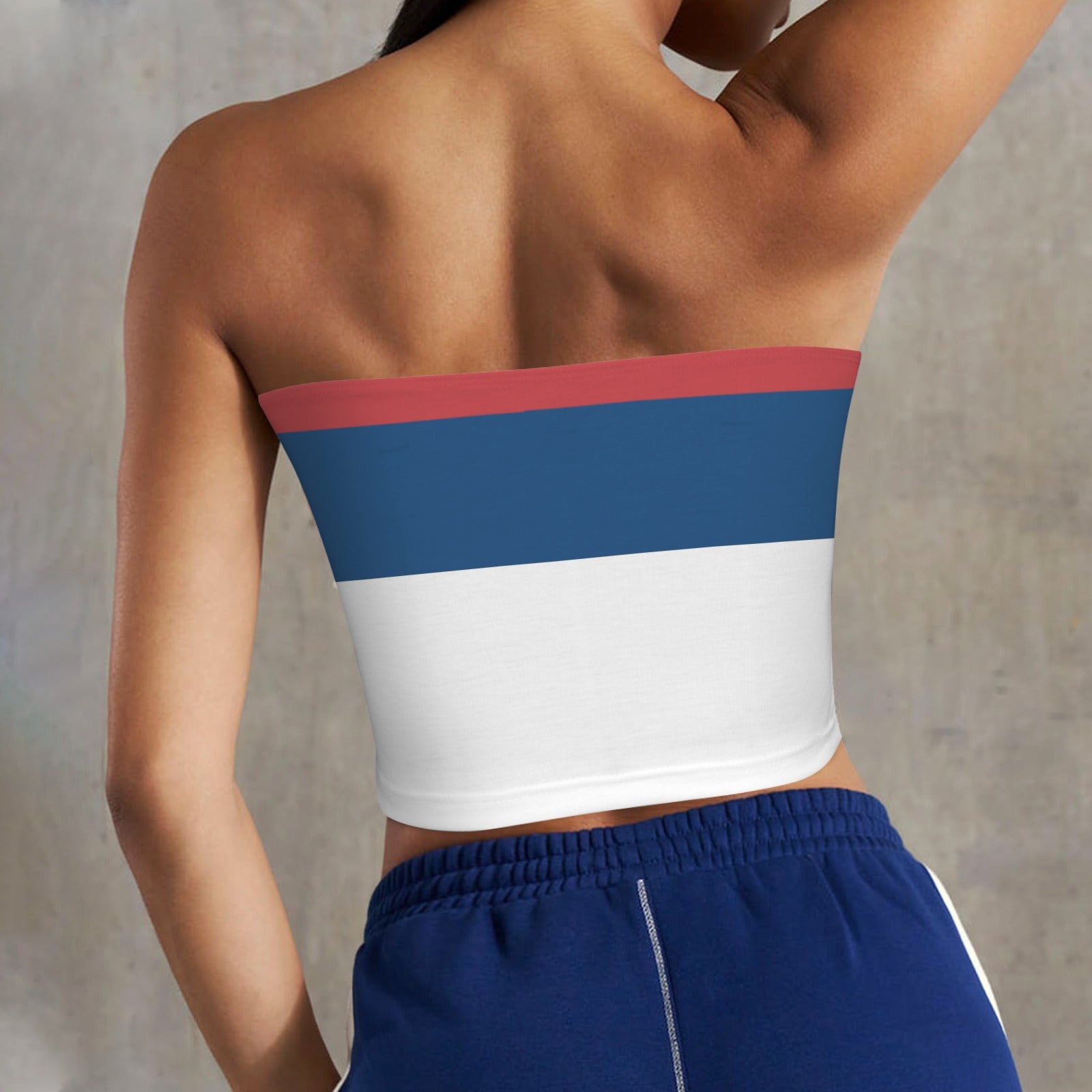 Woman wearing [Brand] strapless top with blue and white.