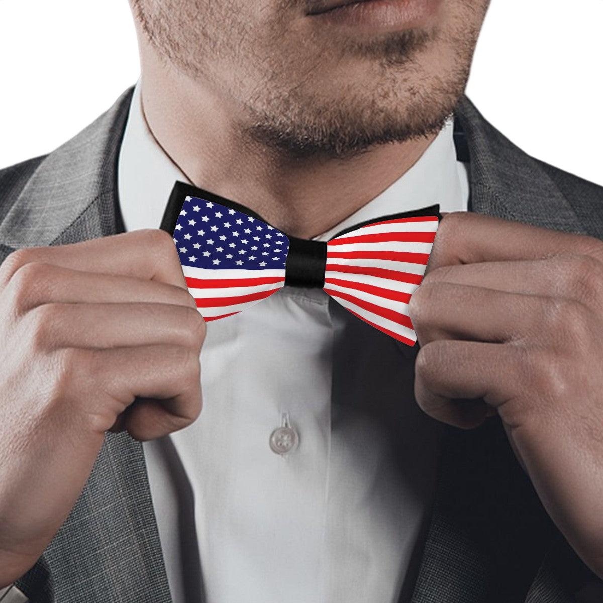 Man adjusting [Brand] American flag bow tie, wearing suit.