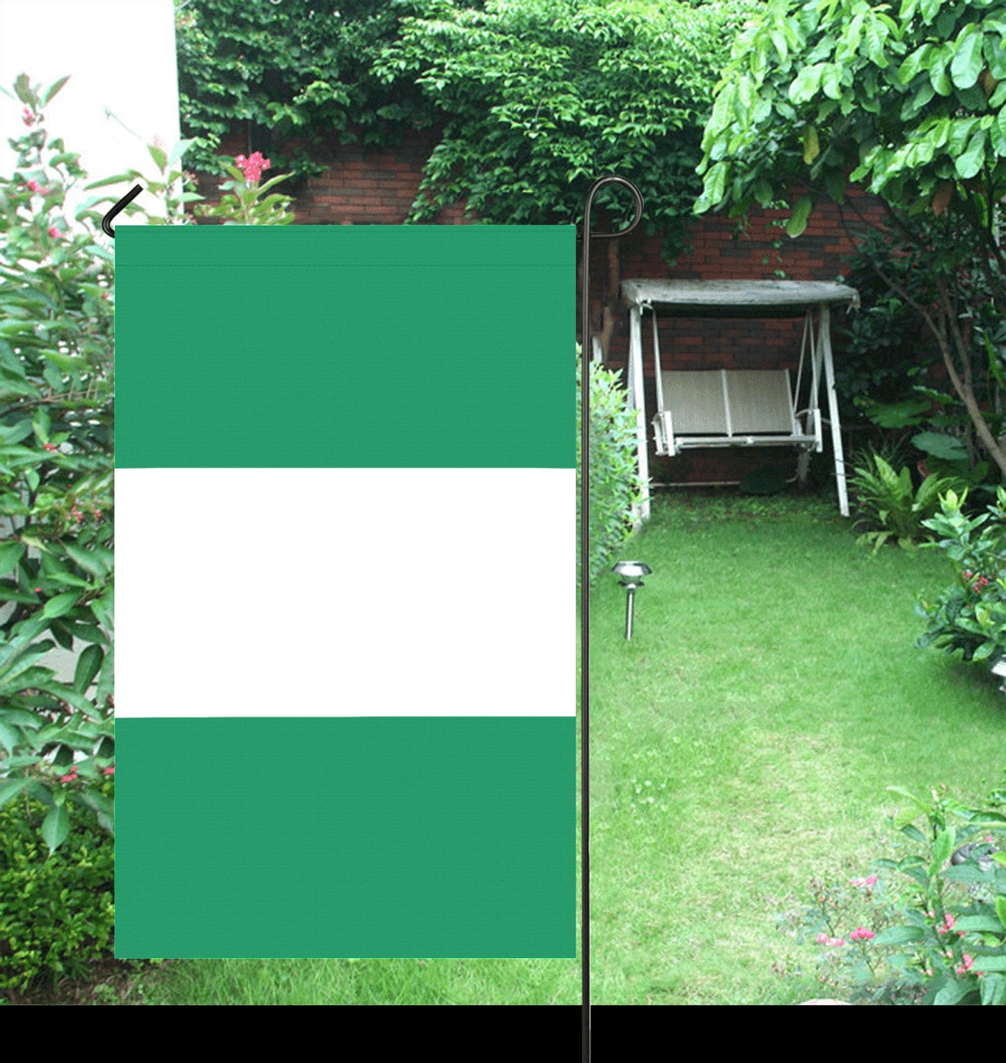 Garden scene with [Luv My Flag] green and white flag.
