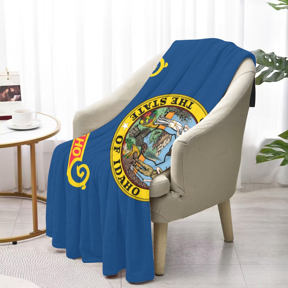 Cozy chair with Luv My Flag Idaho blanket draped.
