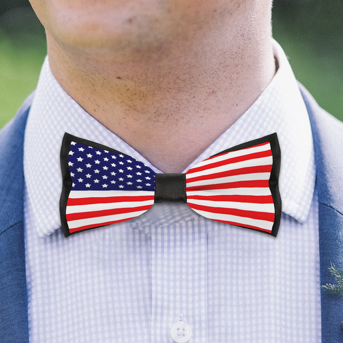 Man wearing [Brand] American flag bow tie, blue suit.
