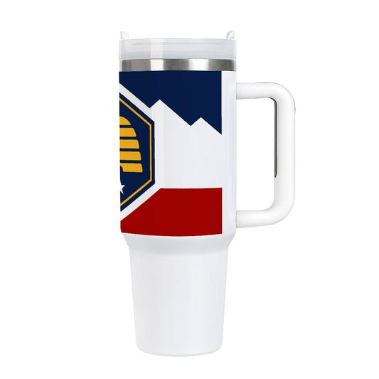 White travel mug featuring colorful [Brand] geometric design and handle.