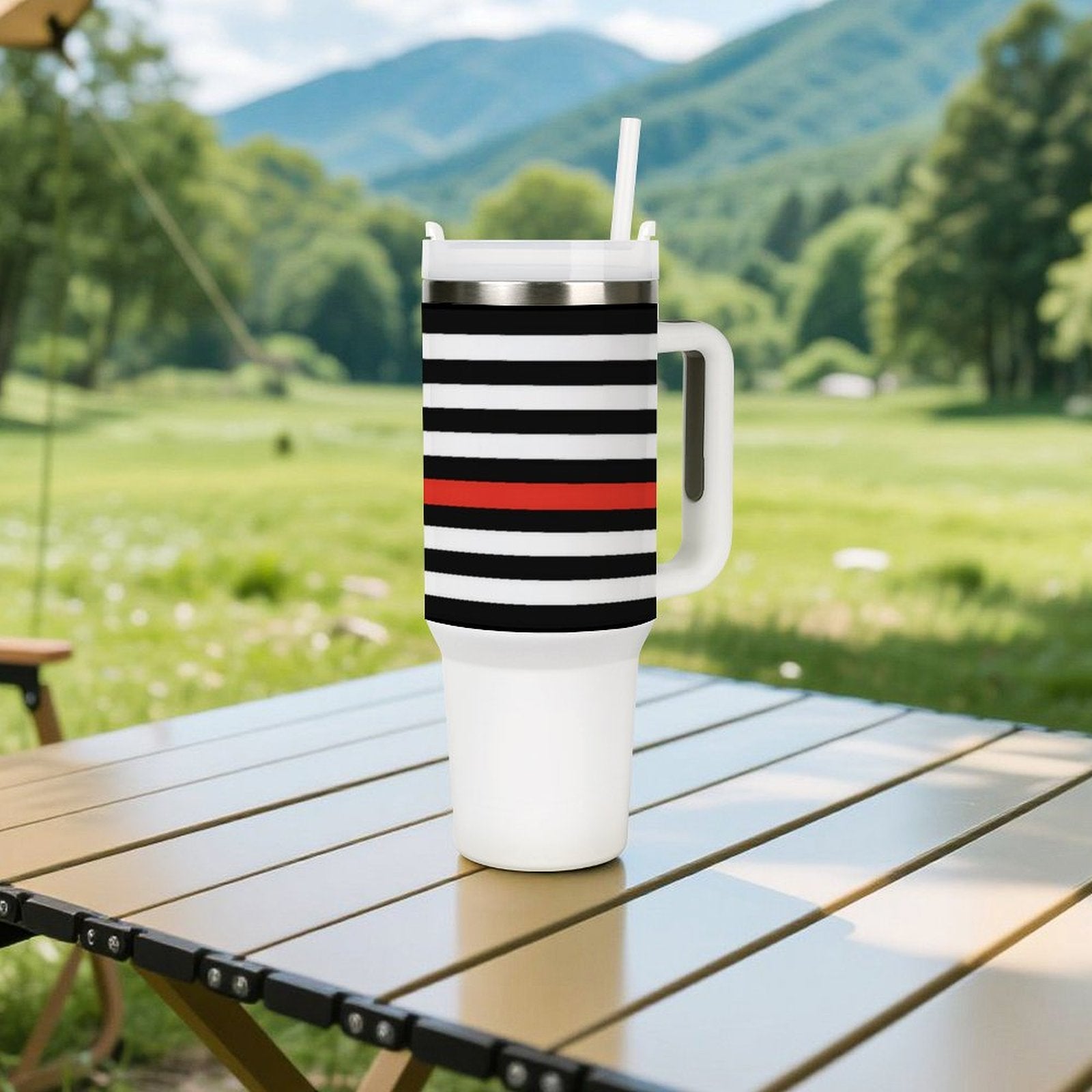 [Brand] travel mug with stripes on outdoor table, nature.