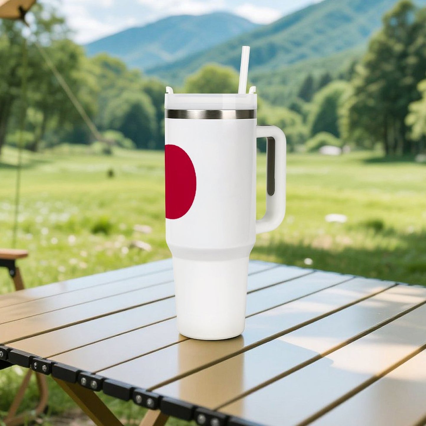 [Brand] tumbler with straw on table, scenic mountain background.