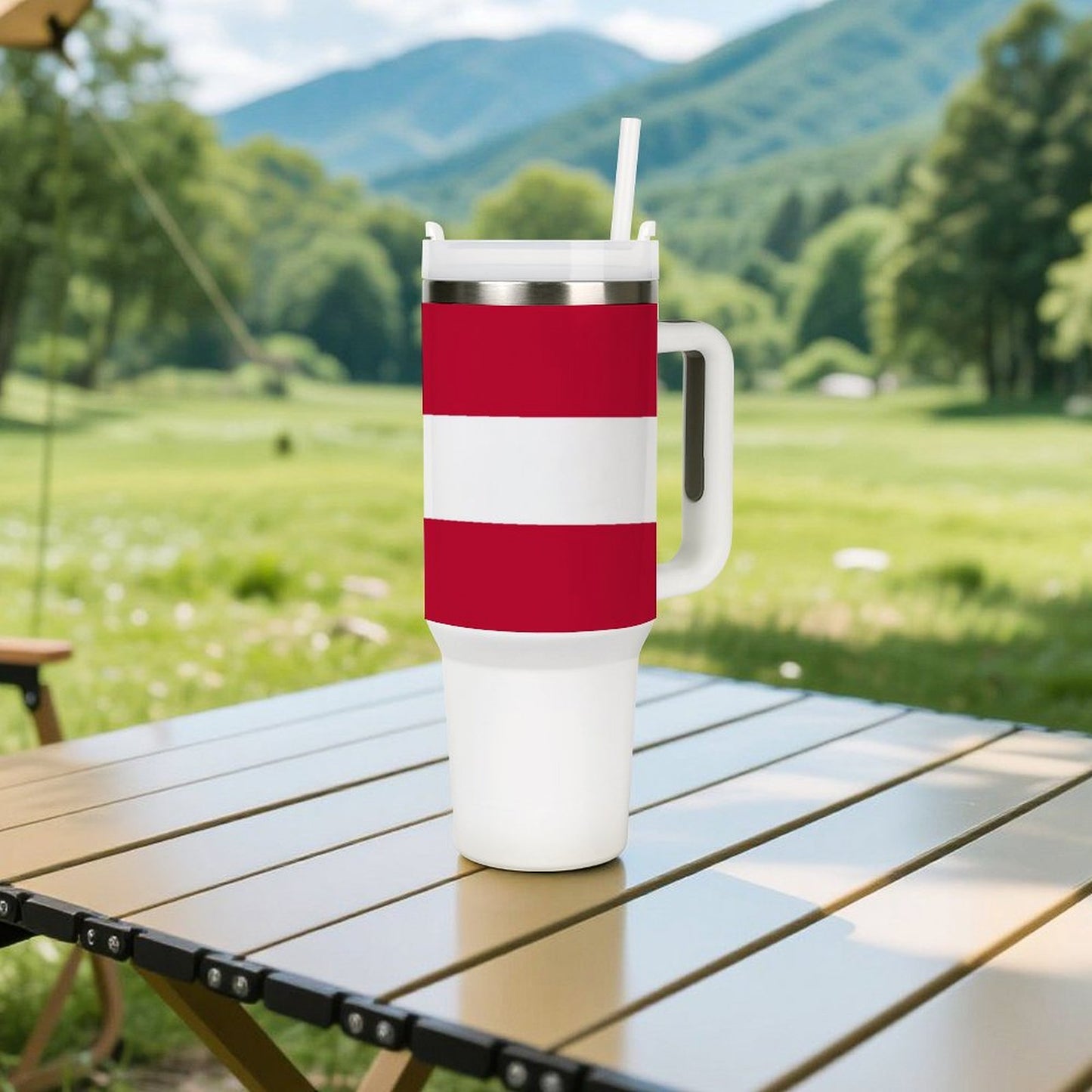 [Brand] mug with red stripes on picnic table outdoors.