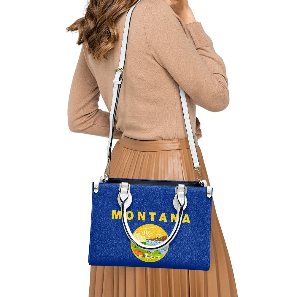 Woman carrying [Brand] Montana-themed blue handbag with design.
