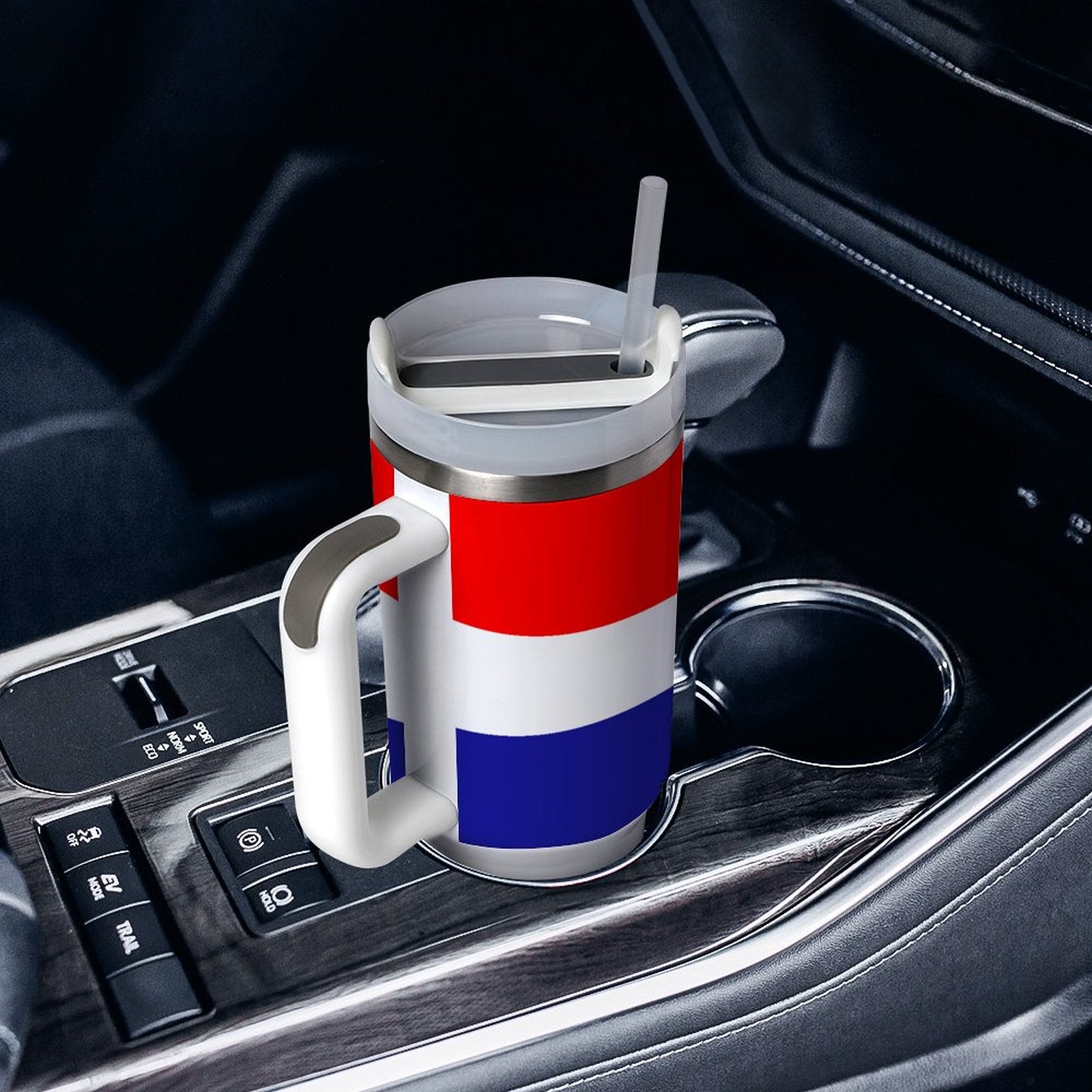 [Brand] travel mug with straw in car cup holder.