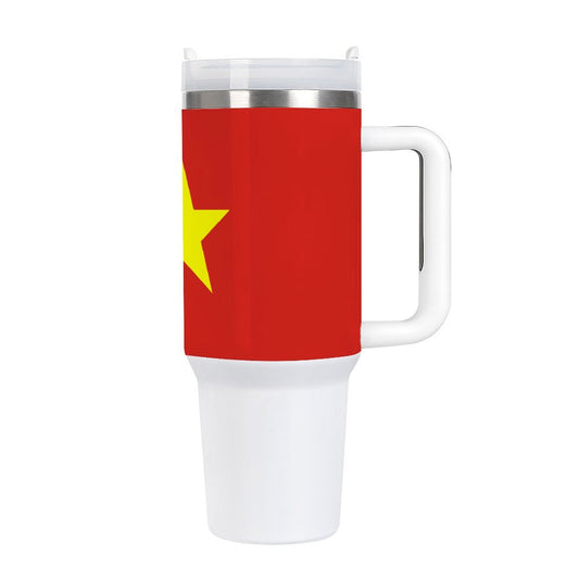 Red [Brand] travel mug with yellow star and handle.