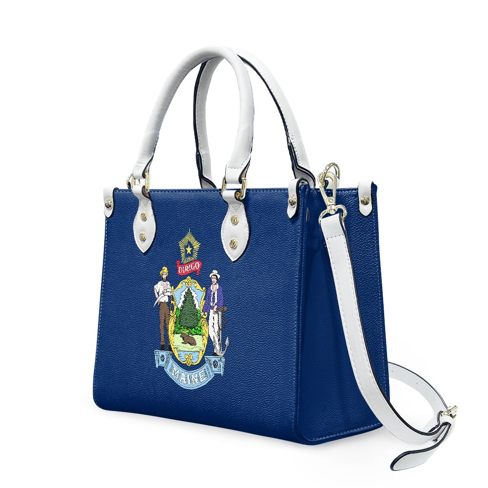 Blue handbag with Maine design, [Brand], white handles, strap.