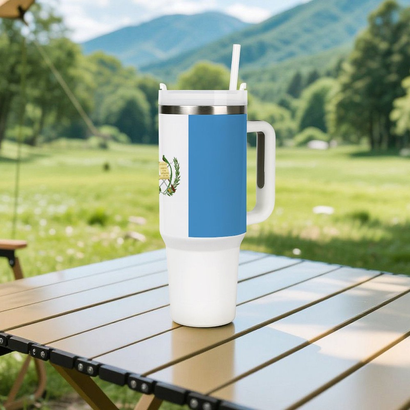 [Brand] travel mug on table with scenic mountain background.