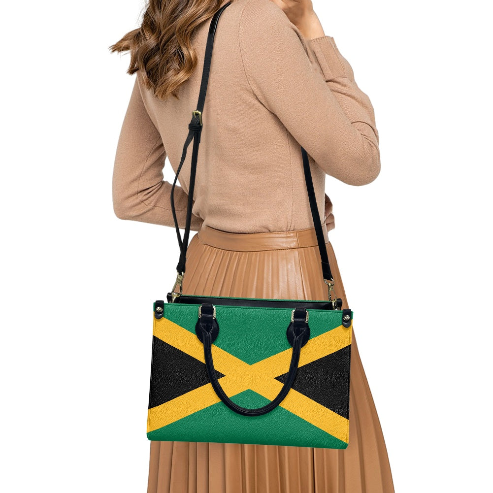 Woman wearing [Brand] handbag with Jamaican flag design.