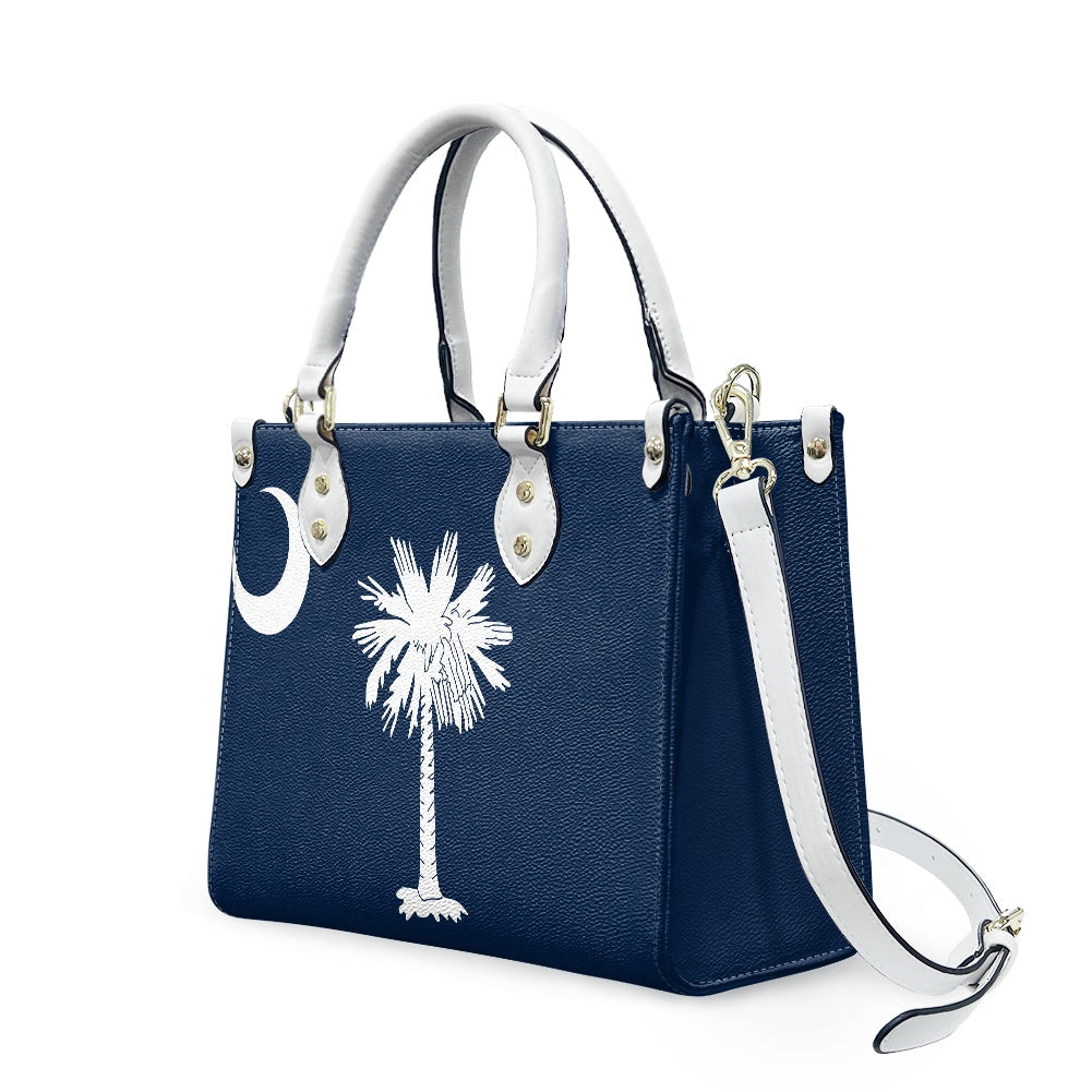 [Brand] navy handbag with white palm tree design.
