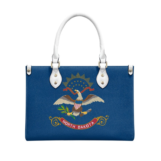 Blue handbag with North Dakota emblem, white handles. [Brand]