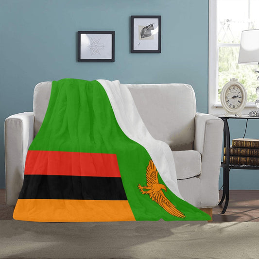 Cozy sofa with Luv My Flag Zambia-themed blanket draped.