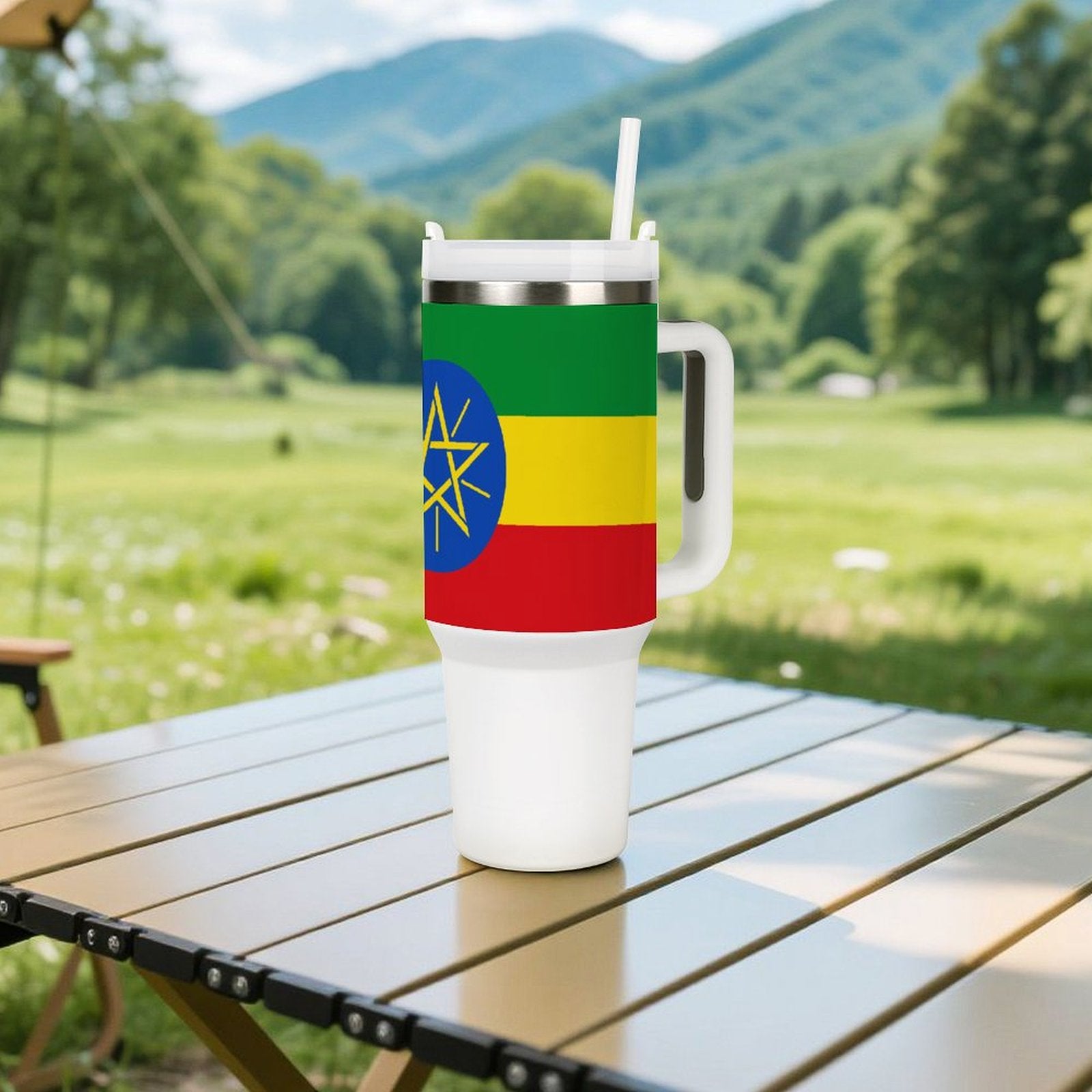 [Brand] travel mug with Ethiopian flag on outdoor table.