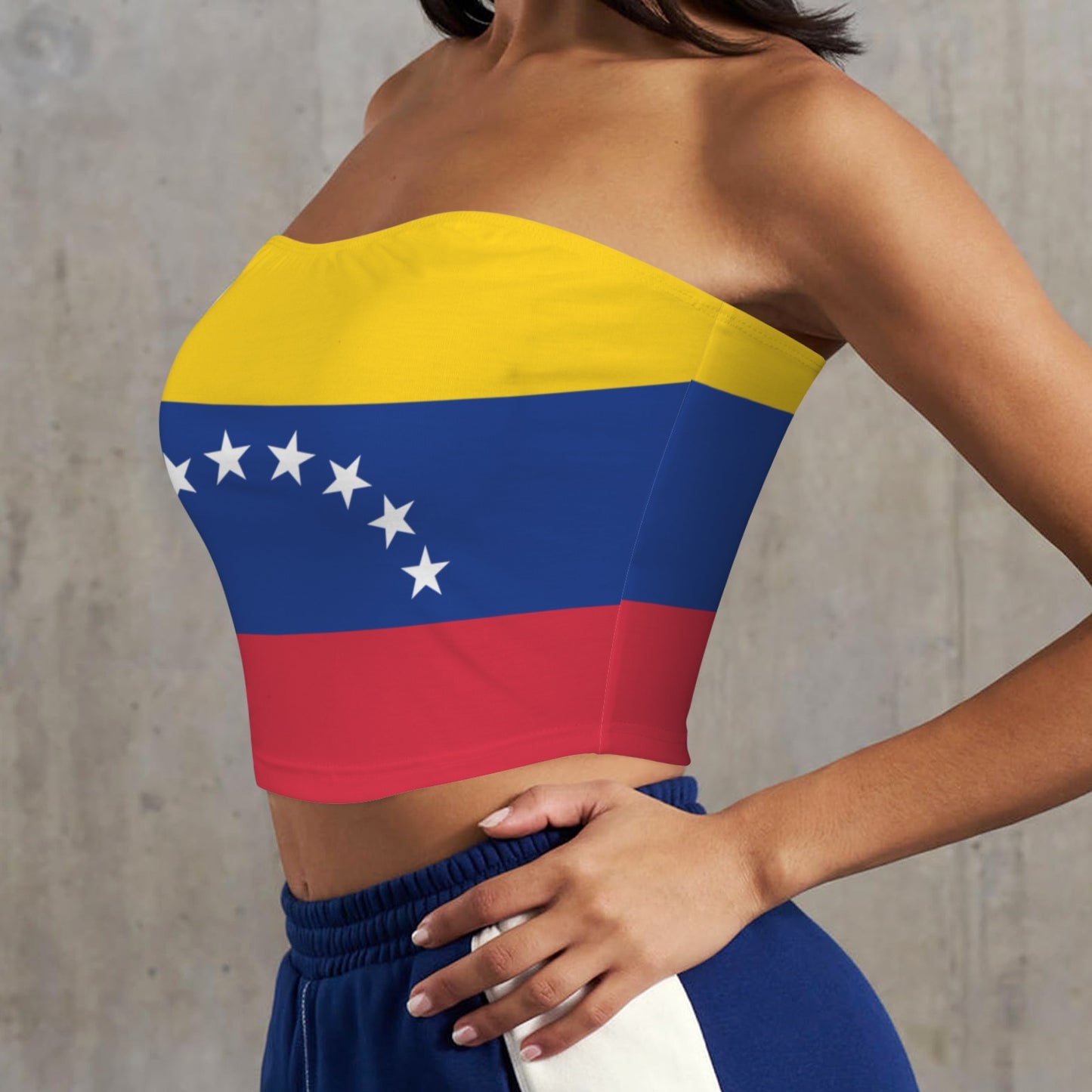 Woman wearing [Brand] strapless top with Venezuelan flag design.