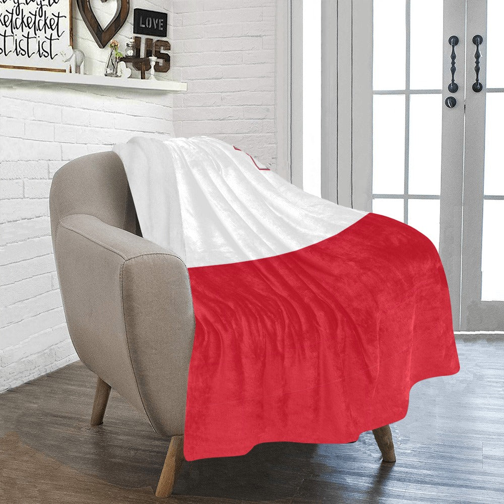 Gray chair with red Luv My Flag blanket draped.