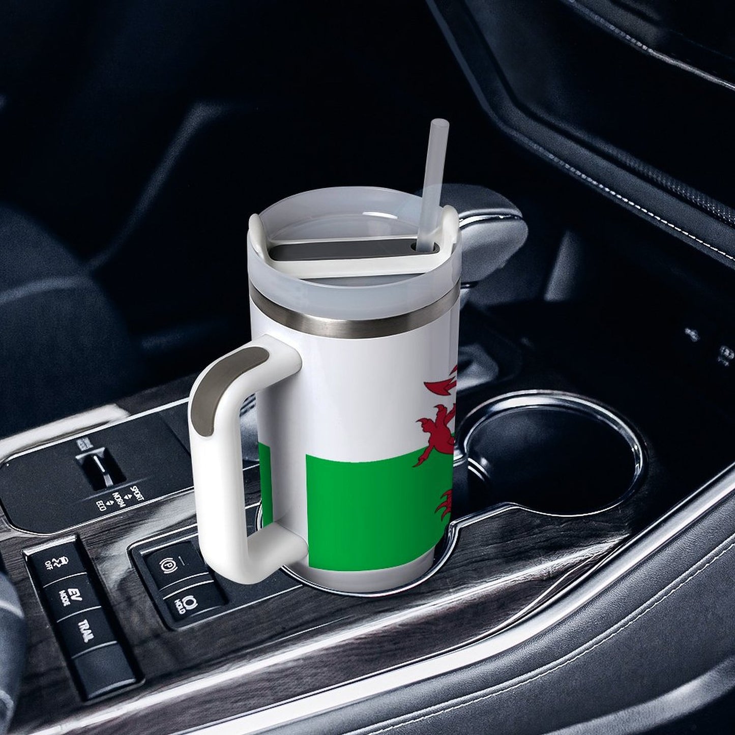Travel mug with Welsh flag design in car cup holder. [Brand]