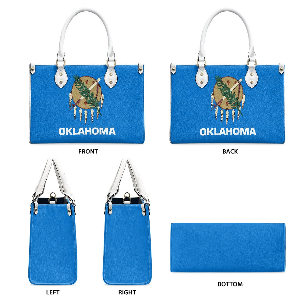 Blue [Brand] handbag with Oklahoma flag design, white handles.